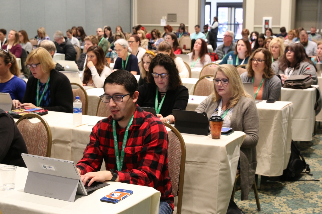 ATIA attendees smile and gather in Orlando for one of the education sessions. Each year, we come together to connect and learn about the latest in assistive technology and share with our peers. We are excited to bring our community back together in-person this year.