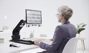 woman with magnifying camera device showing text 