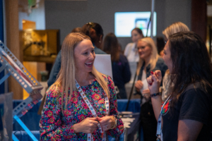 Exhibit Hall attendees talk to one another at ATIA 2024 as they explore the latest products in assistive technology.