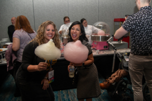Two ladies at ATIA 2024 enjoy cotton candy at the first-ever ATIA Celebration party!