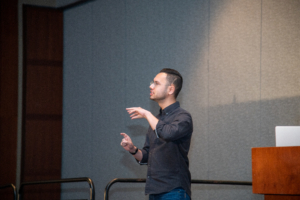 ATIA 2024 speaker uses sign language for his education session.