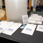 ATIA Conference registration bags placed on a table