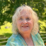 Picture of Sally Norton wearing a green and yellow blouse.