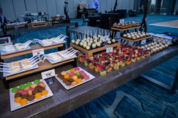 ATIA Celebration dessert table with cake pops, fruit, macarons, lemon meringue, and more